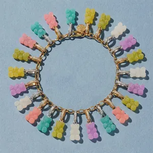Detailed view of a gold chain necklace with colorful macaron gummy bear charms.