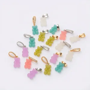 Detailed view of colorful macaron gummy bear pendants with gold and silver bails for DIY jewelry