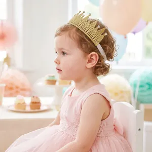Close-up of golden crown elastic headband with rhinestones on a young girl