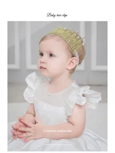 Toddler girl wearing an elegant gold lace crown headband with rhinestones and pearls