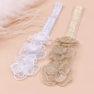 Detailed view of sweet floral lace headbands for children in silver and gold.