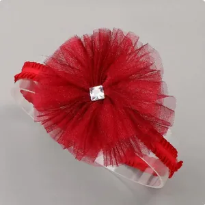 Close-up of red tulle flower headband with a sparkling square rhinestone center