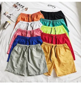 Multiple vibrant colors of quick-dry casual beach shorts displayed on a white fabric background