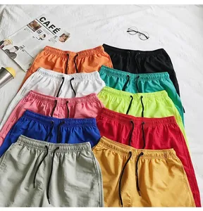 Detailed overhead view of multiple quick-dry beach shorts in various vibrant candy colors
