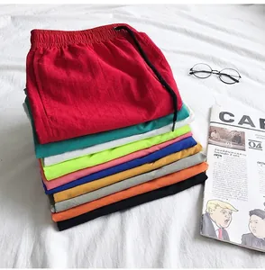 A stack of colorful quick-dry summer beach shorts in various vibrant candy colors