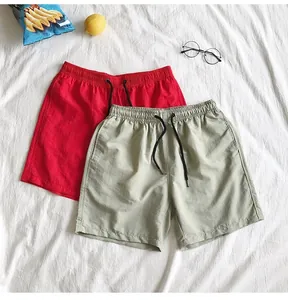 Detailed view of quick-dry summer beach shorts in red and khaki colors