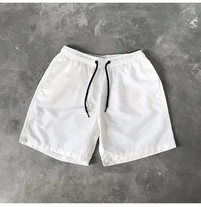 Close-up detail of white quick-dry casual shorts featuring black adjustable drawstring