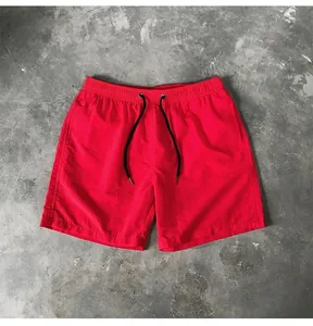 Detailed view of red quick-dry beach shorts with adjustable drawstring waist