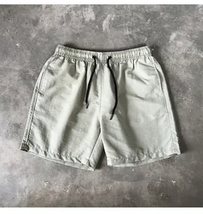 Close-up view of lightweight quick-dry summer casual shorts with drawstring waist on concrete