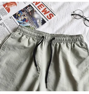 Close-up detail of lightweight quick-dry summer shorts with elastic waist and drawstring.