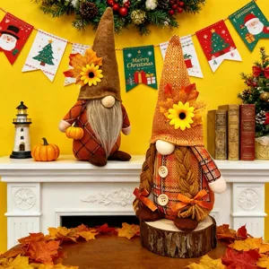 Pair of harvest autumn gnome dolls with sunflowers and maple leaves on a fireplace