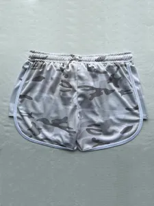 Close-up of camouflage running shorts with breathable mesh fabric and white piping