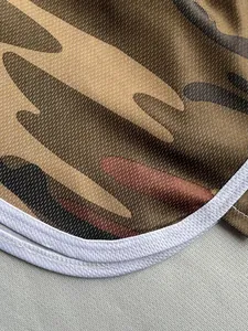 Detailed macro shot showing the breathable mesh texture of camouflage print sports shorts