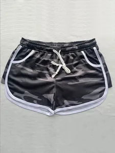 Detailed close-up view of women's camouflage drawstring sports shorts with white trim