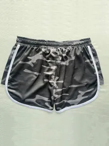 Detail of breathable mesh camouflage shorts with white contrast piping and elastic waist.