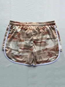 Detailed view of women's camouflage athletic shorts featuring white trim and breathable fabric