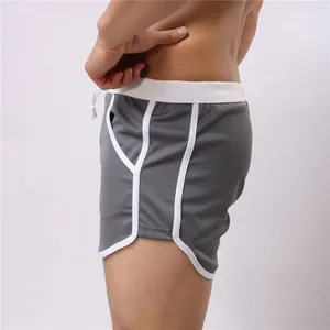 Side view detail of breathable grey mesh sports shorts with white piping for men