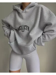 Detail view showing the fabric texture and letter print of this grey oversized hoodie