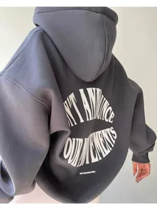 Rear view of an oversized charcoal hoodie with white circular letter print design.