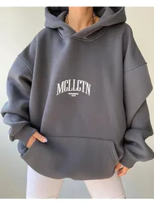 Close-up of a grey oversized hoodie featuring a white graphic letter print design on chest