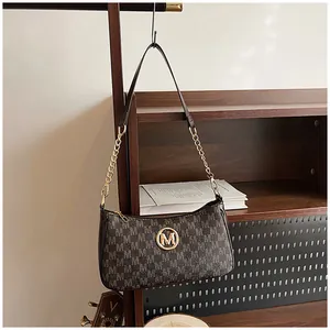 Chic monogram crescent shoulder bag with gold-tone chain strap and underarm design