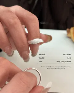 Close-up detail of S925 sterling silver wavy ring showing unique brushed matte texture