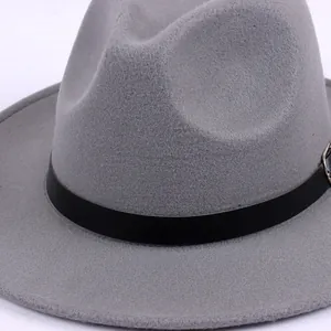 Close-up of a classic grey felt fedora hat with a black band and retro British style.