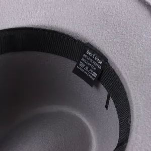 Detailed interior of a gray wool felt fedora hat featuring a high-quality care label