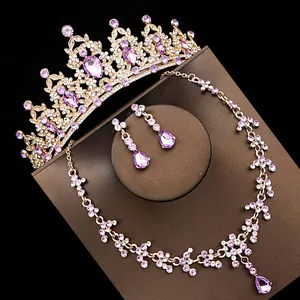 Close-up detail of bridal jewelry set featuring purple crystals and elegant gold tiara