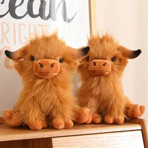 Realistic Highland Cow plush toys with long ginger fur on a wooden surface.