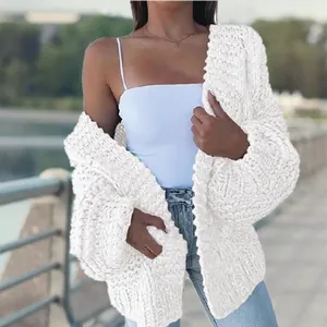 Detailed close-up view of a white chunky cable-knit oversized cardigan sweater jacket