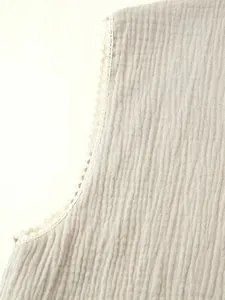 Detailed close-up showing the vintage beige crinkled fabric and delicate floral lace trim