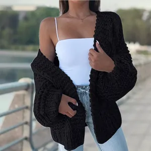 Detail of women's black oversized chunky cable knit cardigan with long sleeves