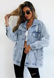 Close-up detail of women's light wash distressed denim jacket featuring ripped accents.