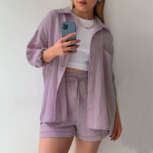 Detailed view of women's purple crinkle fabric shirt and drawstring shorts set