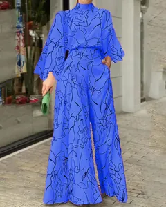 Tuta blu alla moda a gamba larga con stampa astratta nera e maniche lunghe a campana.