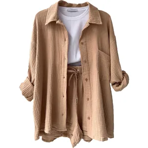Detailed view of casual women's beige crinkled fabric two-piece shirt and shorts set