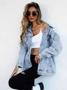 Women's stylish distressed denim jacket with ripped details in casual streetwear style.