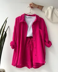 Detail view of the pink crinkle fabric two-piece set featuring shirt and drawstring shorts