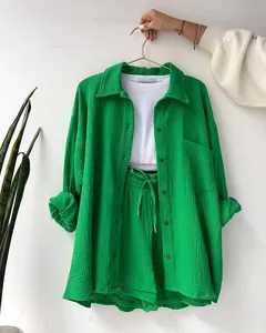 Detail view of stylish women's vibrant green two-piece set in textured crinkle fabric