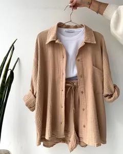 Casual beige two-piece lounge set with textured button-down shirt and drawstring shorts