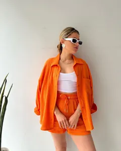 Detail view of stylish orange crinkle texture shirt and drawstring shorts two-piece set