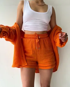 Vibrant orange two-piece gauze set with long-sleeve shirt and high-waist drawstring shorts