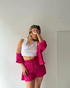 Fashionable fuchsia pink two-piece set with long-sleeve shirt and drawstring shorts