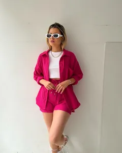Stylish fuchsia two-piece textured shirt and drawstring shorts set shown on a model