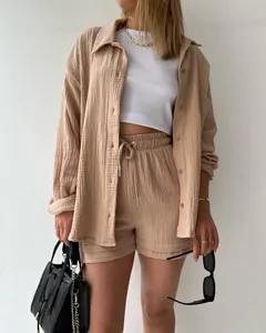 Close-up detail of women's casual crinkle fabric shirt and high-waisted drawstring shorts set