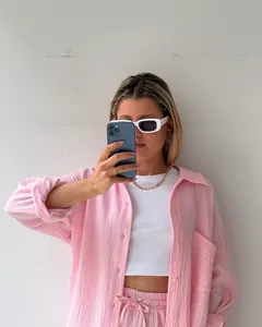 Detail showing a pink crinkle two-piece set with long-sleeved shirt and casual shorts