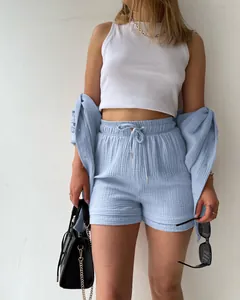 Close-up of light blue crinkle fabric two-piece set with shirt and drawstring shorts
