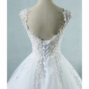 Exquisite close-up of the lace-up corset back detail on a white French bridal wedding dress