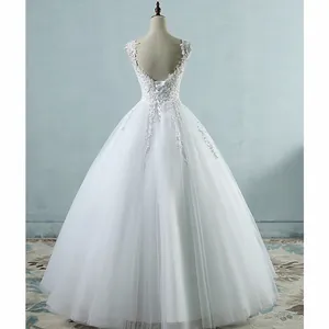 Back view of elegant white backless wedding dress with lace-up detail and tulle skirt